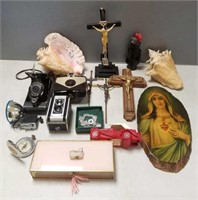 Group including crucifixes, cameras, conch shells,