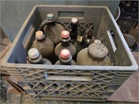 Plastic crate of vintage bottles