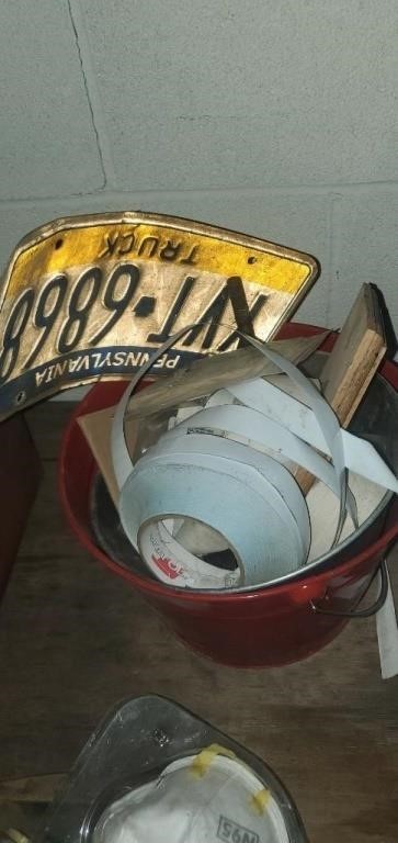 Bucket of random stickers, and license plate.