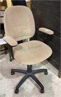Tan suede-like cushioned swivel office chair on