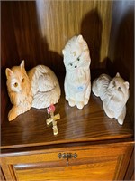 3 ceramic cats & cross on shelf