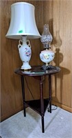 Side table, oil lamp, electric lamps and 2 prints