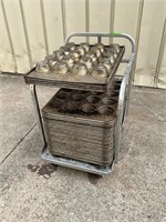 Lot of muffin pans and bakery cart