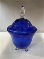 Blue glass pedestal candy dish has a few chips on