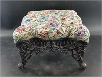 Upholstered cast iron footstool, very detailed in