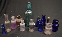 Quantity of small antique coloured glass bottles