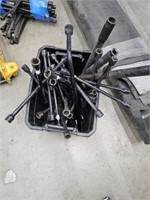 Tub of 4 way lug wrenches and jack handles