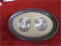 Cupid awake/asleep oval tin frame.