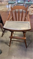 Wood high chair with a metal tray