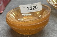 Three small orange, carnival glass bowls