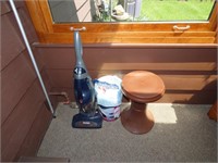 Vacuum, trash can, plant stand.