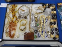A TRAY FILLED WITH MISC. COSTUME JEWELRY AND