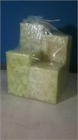 Group of four green pillar candles sealed in