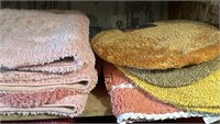 Shelf of misc bathroom rugs