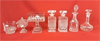 Assortment of glass decanters, raised candy dishes