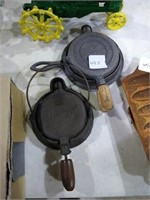 Miniature cast iron waffle irons. 
One marked