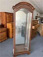 Lighted curio cabinet with solid glass front,