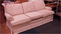 Upholstered  three-cushion sofa  in cream with