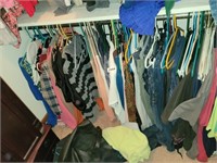 BOTTOM 1/2 CLOSET FULL OF CLOTHES