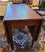 Drop leaf table. Folds to 42"×21". Opens to