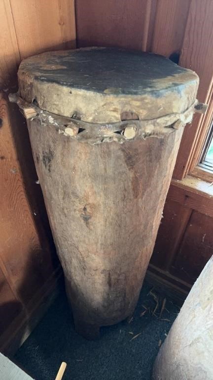 Tall carved wood tree trunk, African drum, with a