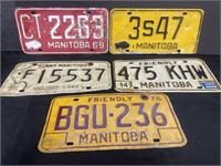 Collection of five Manitoba licence plates.