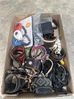 Assortment of leather bracelets, old cell phone,