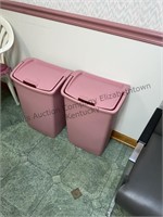 2 pink trash cans