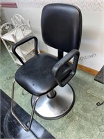 Hairdresser chair swivels and is adjustable