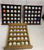 75 advertising golfballs in 3 display racks