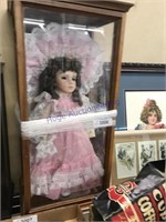 Porcelain doll in showcase, 11.5 x 9 x 25.5" tall