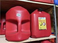 THREE GAS CANS .