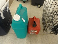 2 plastic gas cans with fluid inside