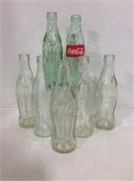 7 Coca-Cola Bottles