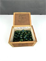 Small cigar box with glass marbles