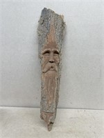 Carving of face in wood