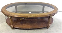 Oval wood and glass top coffee table