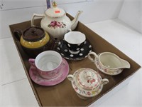 Tea pots, cream and sugar, cup and saucers