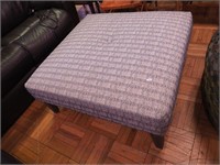 Large ottoman with blue and white upholstery,