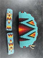 An intricately beaded coin purse with barrettes in