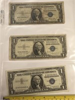 Three blue seals, one dollar bills dated 1935,