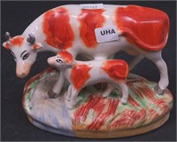 A Staffordshire figurine of cow and calf