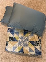 Blue patchwork quilt and two new pillows