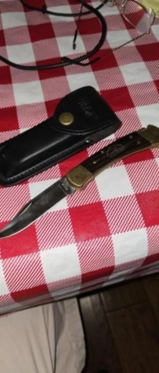 Buck 110 folding knife with leather case