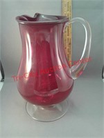 Red glass pitcher with clear handle and base -