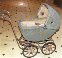 wicker doll carriage with wooden wheels and