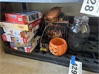 Shelf lot of puzzles and Halloween decorations