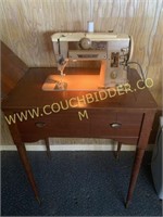 Singer sewing machine and wooden cabinet