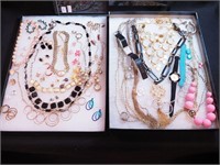 Two containers of costume jewelry: Kendra Scott,