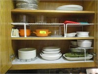 Bowls and misc in cabinet left of stove